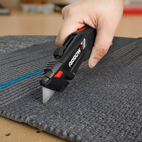 Arrow brand carpet knife on a piece of gray carpet.