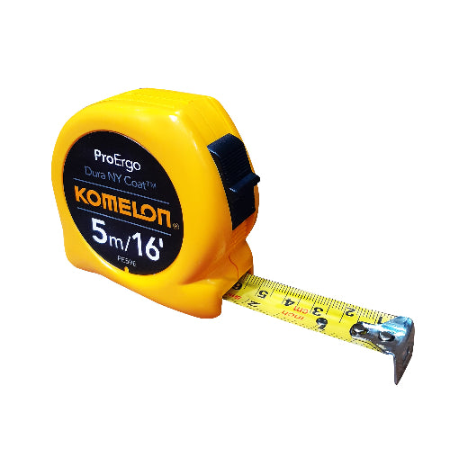 A yellow and black Komelon Proergo pocket tape measure with a nylon coated blade, model 5M/16Ftx19mm, extended to show length markings.